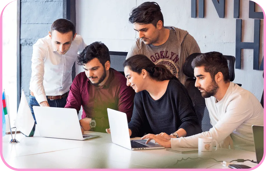 AmzoCare team collaborating around a laptop